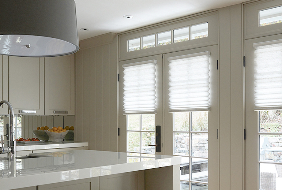 White grand pleated shades on French doors by Blinds To Go let in tons of light in this modern kitchen.