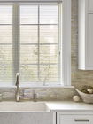 Aluminum mini blinds above the kitchen sink offer a sleek, durable, and moisture-resistant window solution.