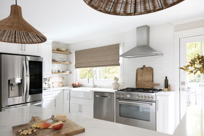 Bright kitchen with cozy brown accents and neutral Roman shades.