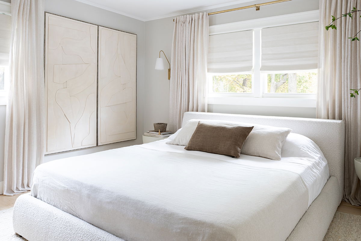 A cozy neutral bedroom with floor-to-ceiling drapery.