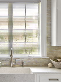 Aluminum mini blinds above the kitchen sink offer a sleek, durable, and moisture-resistant window solution.