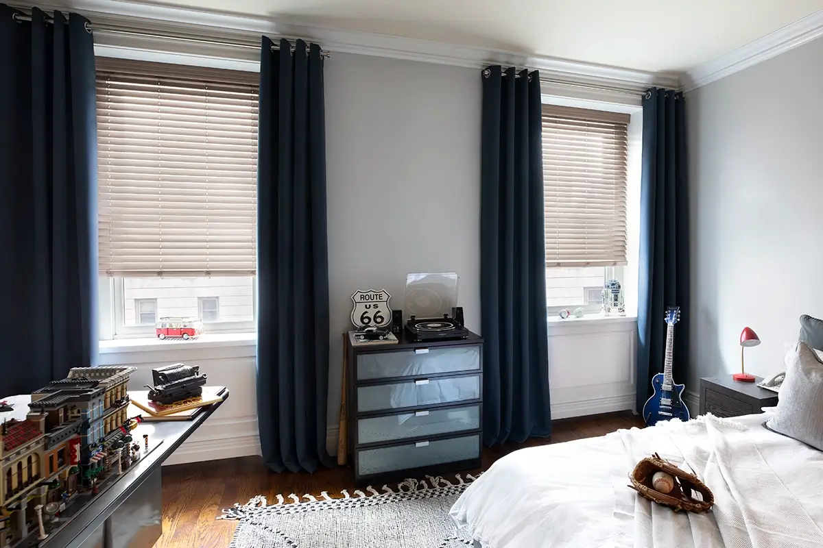 Drapes paired with aluminum blinds in a child's room