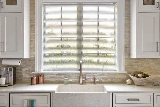 Cordless white mini blinds in a kitchen, providing a clean, modern look with convenient light control and safety features.