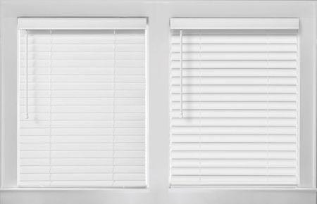 Side-by-side comparison of wooden blinds and faux wood blinds, highlighting differences in texture and material.