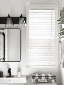 Faux wood blinds in the kitchen, providing a durable, moisture-resistant, and stylish window treatment option