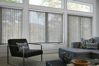 Vertical blinds made of custom fabric for sliding glass doors provide privacy and a modern room.