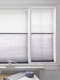 Honeycomb shades or cellular shades on a window, providing energy efficiency, insulation, and stylish light control