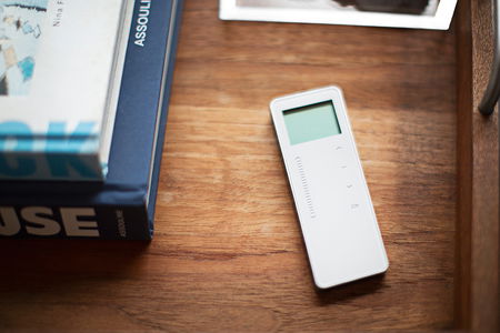 A close up image of a remote control on a tabletop