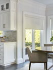 Dining area with white roller shades on windows Dining area with white roller shades on windows