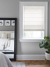 Roman shades in a bedroom, adding elegance, privacy, and soft light control for a cozy, stylish space