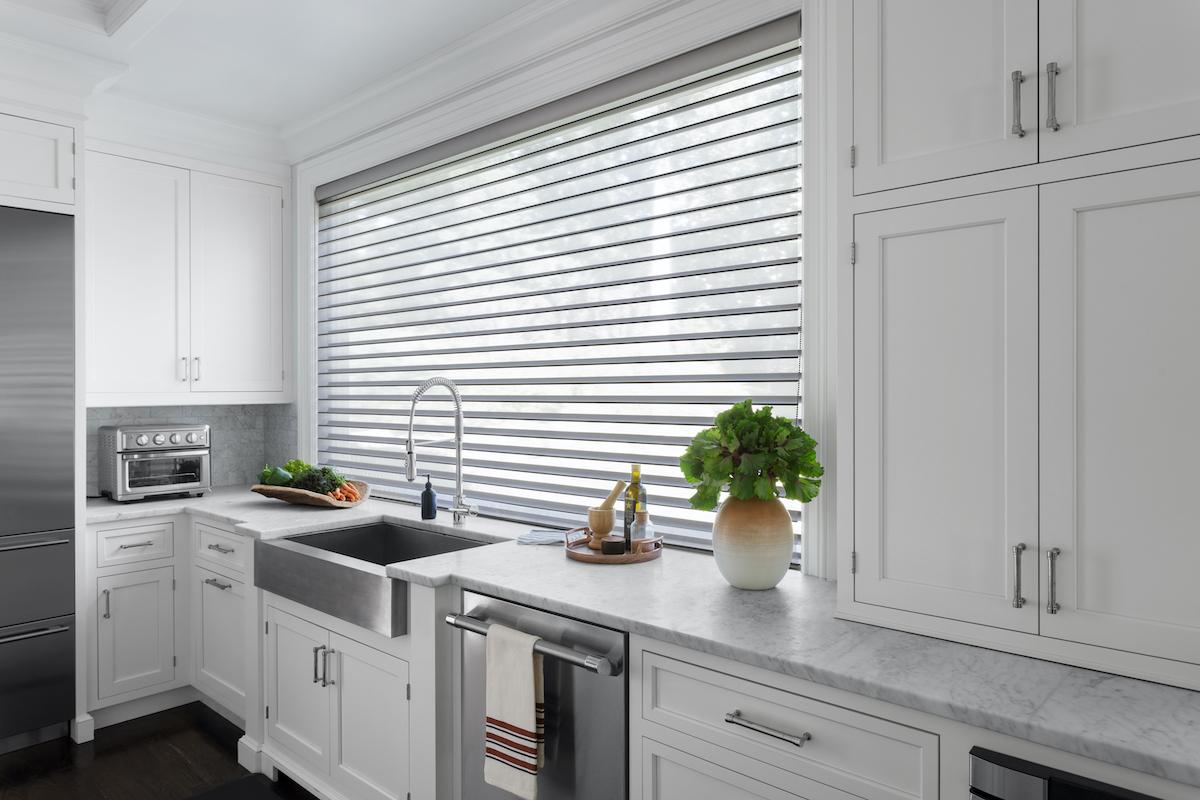 A large kitchen window covered with Serenity sheer window shades