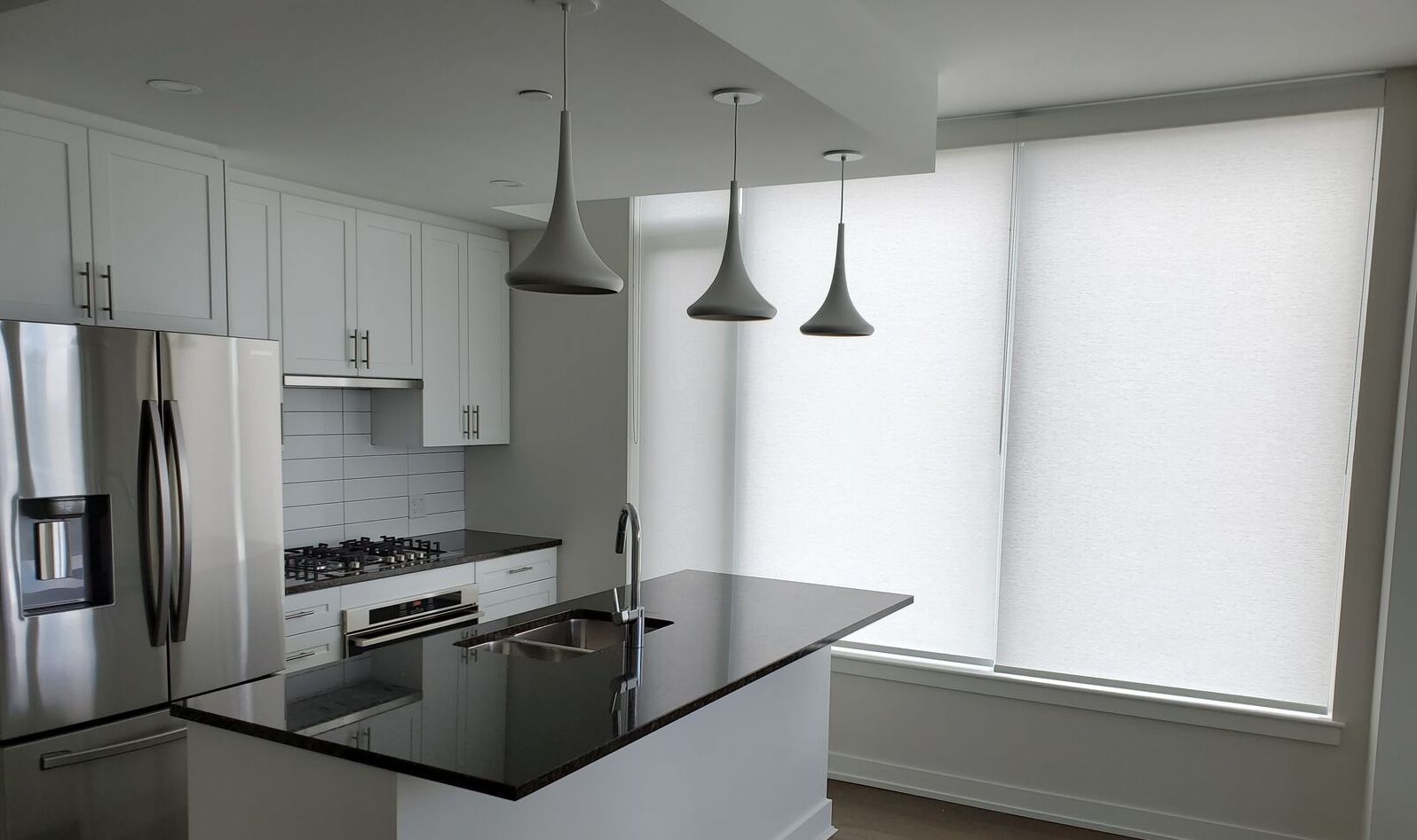 Opaque solar shades provide privacy in a modern kitchen