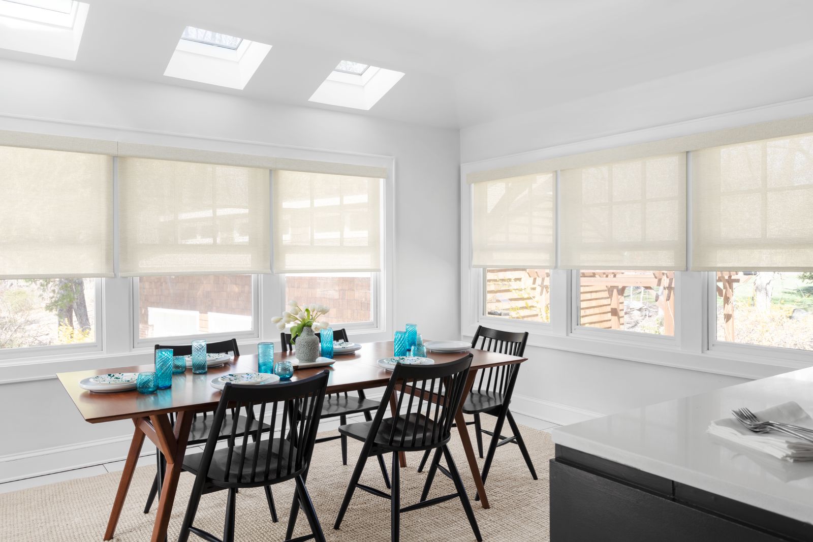 Cream-colored solar shades in a modern dining room