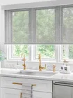 Solar Shades Solar shades in a kitchen above the sink, providing UV protection, glare reduction, and a modern aesthetic
