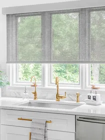 Solar shades in a kitchen above the sink, providing UV protection, glare reduction, and a modern aesthetic