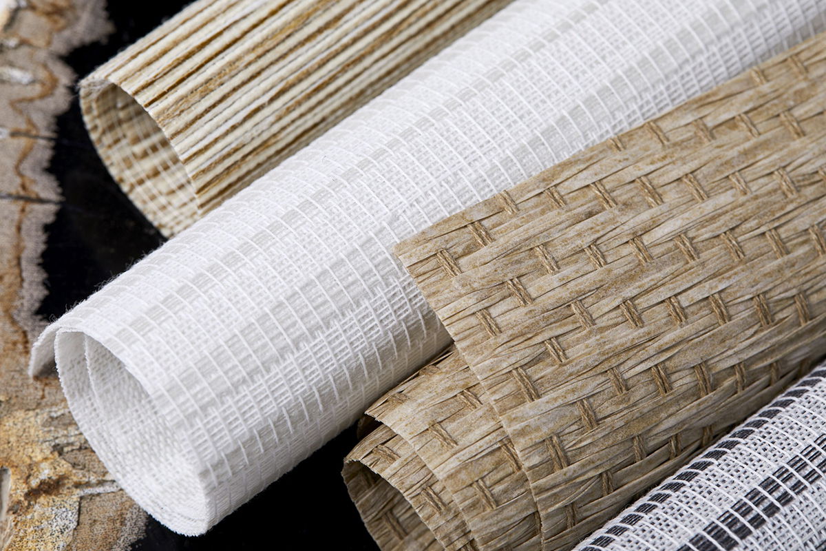 A close up image of woven wood shade swatches shows the beautiful texture and natural colors available.